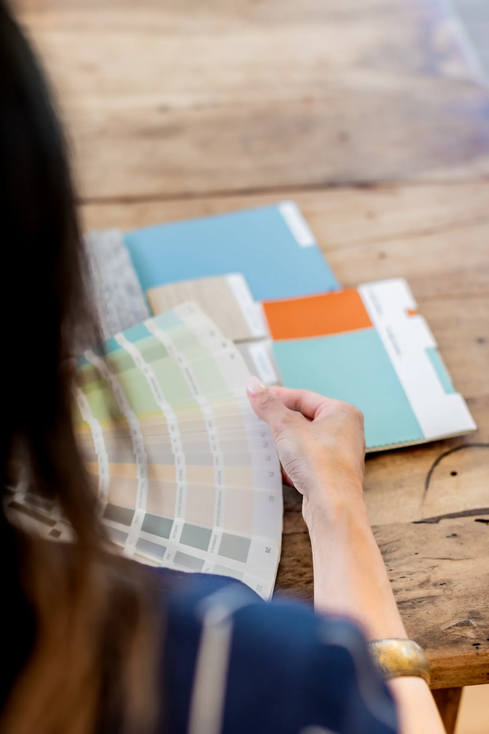 Elaine Gan reviewing a fan of colour swatches